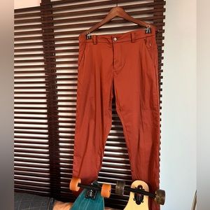 Lululemon Commission pant in orange. Size 32 waist and 34 length.